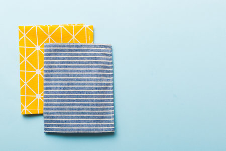 top view with blue kitchen napkin isolated on table background. Folded cloth for mockup with copy space, Flat lay. minimal style.の写真素材