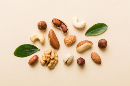 Composition of nuts , flat lay - mix hazelnuts, cashews, almonds on table background. healthy eating concepts and food background.の写真素材