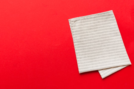 top view with gray kitchen napkin isolated on table background. Folded cloth for mockup with copy space, Flat lay. minimal style.の写真素材