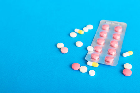 Blister package with Vitamin on color background. Medicine pills on a light background. Medicines...