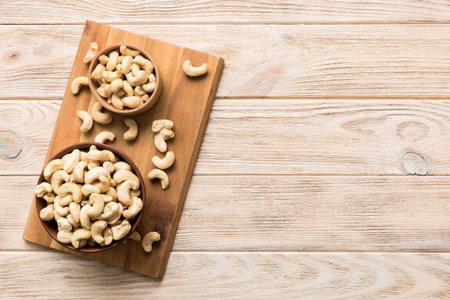 cashew nuts in wooden bowl on table background. top view. Space for text. healthy foodの写真素材