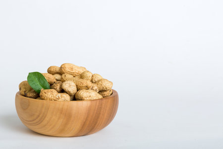 Fresh healthy peanuts in bowl on colored table background. Top view Healthy eating bertholletia...