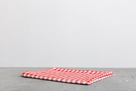 top view with red empty kitchen napkin isolated on table background. Folded cloth for mockup with...