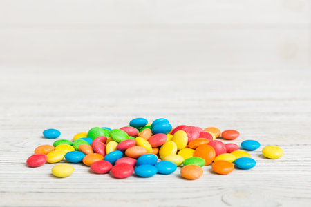 Pile of delicious colorful sweet candies on colored background top view. Confectionery decor.の写真素材