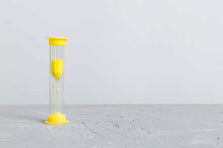 hourglass on the table, sand clock as time passing concept for business deadline, copy space.の写真素材