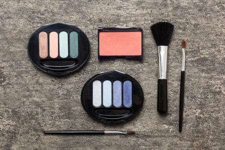 professional makeup tools. top view. flat lay. Beauty, decorative cosmetics. Makeup brushes set and color eyeshadow palette on table background. minimalistic style.の写真素材