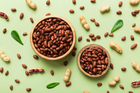 Fresh healthy peanuts in bowl on colored table background. Top view Healthy eating bertholletia concept. super foods.の写真素材