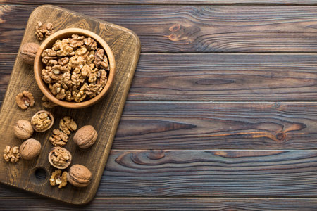 Fresh healthy walnuts in bowl on colored table background. Top view Healthy eating bertholletia concept. super foods.の写真素材