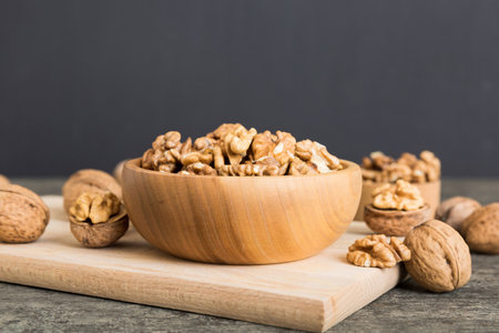 Fresh healthy walnuts in bowl on colored table background. Top view Healthy eating bertholletia...
