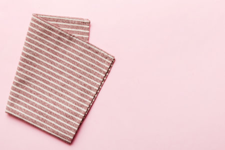 top view with red empty kitchen napkin isolated on table background. Folded cloth for mockup with copy space, Flat lay. minimal style.の写真素材