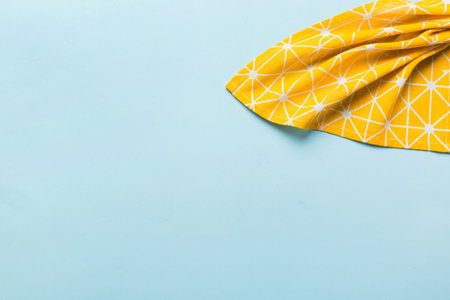 top view with yellow empty kitchen napkin isolated on table background. Folded cloth for mockup with copy space, Flat lay. minimal style.の写真素材