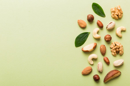 Composition of nuts , flat lay - mix hazelnuts, cashews, almonds on table background. healthy eating concepts and food background.の写真素材