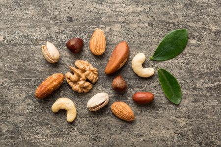 Composition of nuts , flat lay - mix hazelnuts, cashews, almonds on table background. healthy eating...