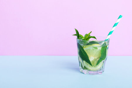 Mojito summer refreshing cocktail with ice and mint. mojito cocktail with lime, lemon and mint in a tall glass with a stick.の写真素材