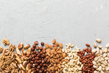 different nuts frame background. Close up, top view, flat lay with vopy space. Walnut, pistachios, almonds, hazelnuts and cashews.の写真素材