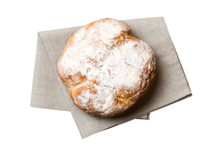 Freshly baked delicious french bread with napkin isolated on white background top view. Healthy...