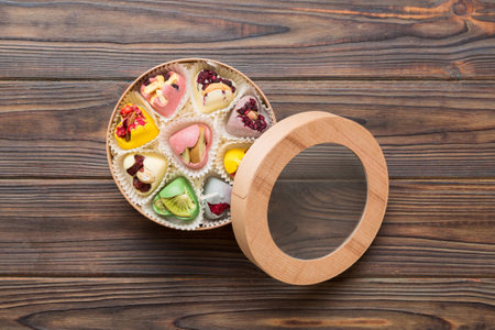 Holiday composition: sweet candy, with gift boxes with bow and chocolate hearts, photo template, background. Top View with copy space on colored background.の写真素材