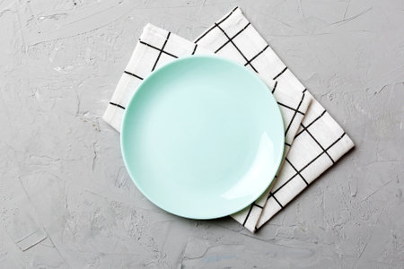 Top view on colored background empty round Blue plate on tablecloth for food. Empty dish on napkin with space for your design.の写真素材