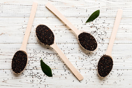 quinoa seeds in spoon on colored background. Healthy kinwa in small spoon. Healthy superfood.の写真素材