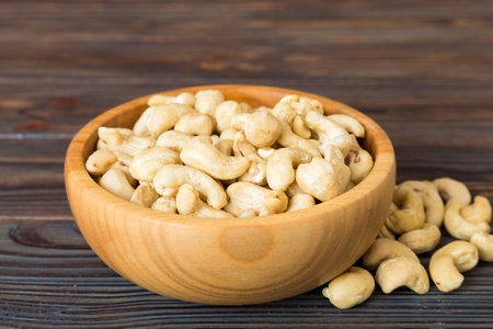 cashew nuts in wooden bowl on table background. top view. Space for text. healthy foodの写真素材