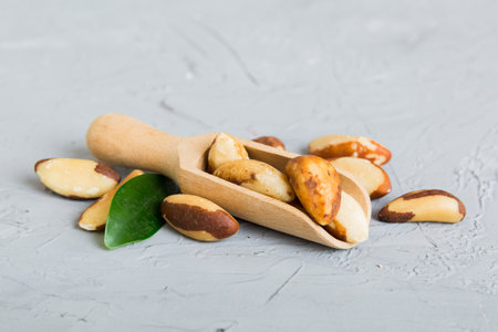 Fresh healthy Brazil nuts in bowl on colored table background. Top view Healthy eating bertholletia concept. super foods.の写真素材