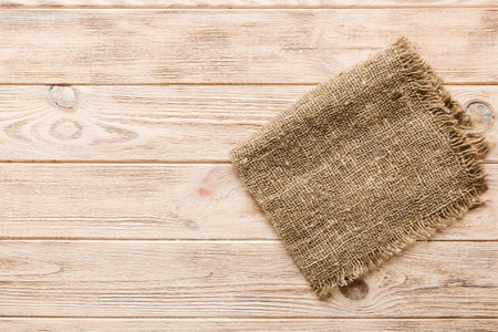 Old burlap fabric napkin, sackcloth on table background. top view with copyspace.の写真素材