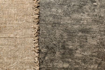 Old burlap fabric napkin, sackcloth on table background. top view with copyspace.の写真素材