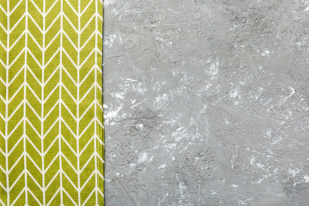 top view with green kitchen napkin isolated on table background. Folded cloth for mockup with copy space, Flat lay. minimal style.の写真素材