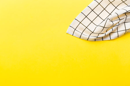 top view with white empty kitchen napkin isolated on table background. Folded cloth for mockup with copy space, Flat lay. minimal style.の写真素材