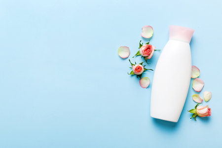 Fancy healthcare bottles for cream with rose flower. Natural oranic spa cosmetics concept. Mockup, template, top view.の写真素材