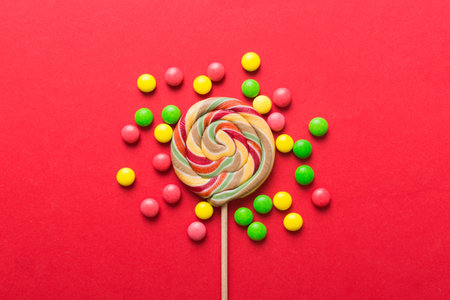 Tasty appetizing Party Accessories Happy Birthday Sweet. Different types of candies on colored background, copy space. Colorful birthday party background.の写真素材