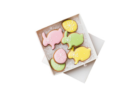 Colorful easter cookies in basket with Multi colors Easter eggs isolated on white background. Pastel color Easter eggs. holiday concept.の写真素材