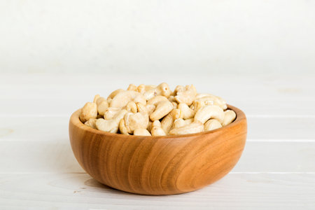 cashew nuts in wooden bowl on table background. top view. Space for text. healthy foodの写真素材