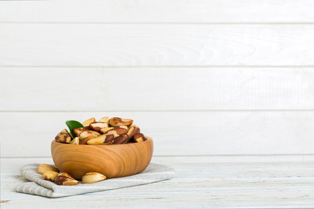 Fresh healthy Brazil nuts in bowl on colored table background. Top view Healthy eating bertholletia concept. super foods.の写真素材