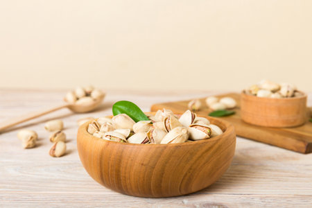Fresh healthy Pistachios in bowl on colored table background. top view. Healthy eating concept. super foods.の写真素材