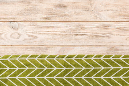 top view with green kitchen napkin isolated on table background. Folded cloth for mockup with copy space, Flat lay. minimal style.の写真素材