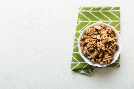 Fresh healthy walnuts in bowl on colored table background. Top view Healthy eating bertholletia concept. super foods.の写真素材