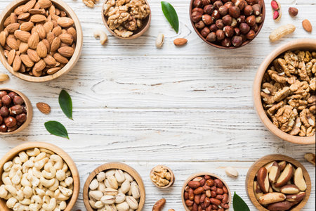 mixed nuts in wooden bowl. Mix of various nuts on colored background. pistachios, cashews, walnuts, hazelnuts, peanuts and brazil nuts.の写真素材