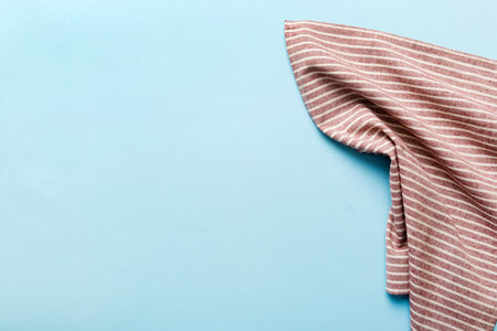 top view with red empty kitchen napkin isolated on table background. Folded cloth for mockup with...