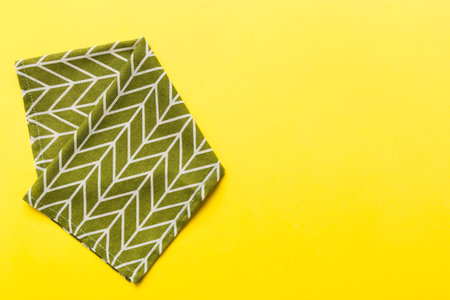 top view with green kitchen napkin isolated on table background. Folded cloth for mockup with copy space, Flat lay. minimal style.の写真素材