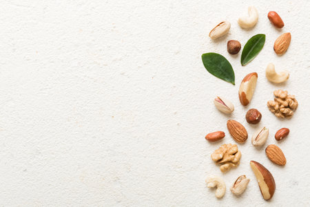 Composition of nuts , flat lay - mix hazelnuts, cashews, almonds on table background. healthy eating concepts and food background.の写真素材