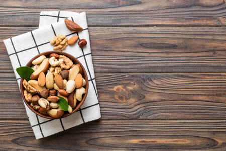 mixed nuts in bowl. Mix of various nuts on colored background. pistachios, cashews, walnuts, hazelnuts, peanuts and brazil nuts.の写真素材