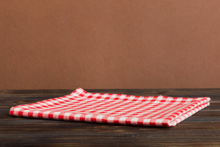 top view with red empty kitchen napkin isolated on table background. Folded cloth for mockup with copy space, Flat lay. minimal style.の写真素材