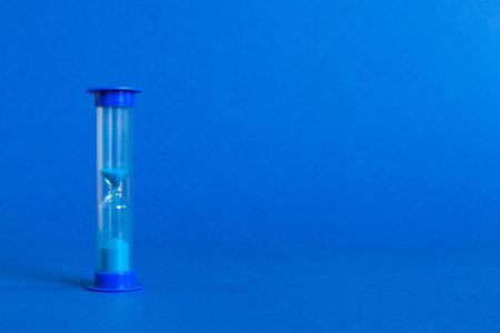 hourglass on the table, sand clock as time passing concept for business deadline, copy space.の写真素材