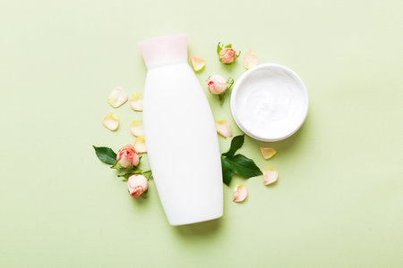 Fancy healthcare bottles for cream with rose flower. Natural oranic spa cosmetics concept. Mockup, template, top view.の写真素材