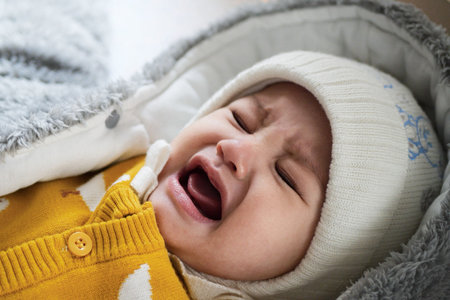 A mother dressing her little baby boy boy at home. childhood parenthood and growing up family concept real people.の写真素材