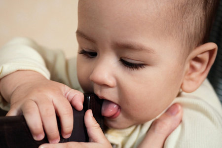 Cute adorable newborn baby playing with colorful rattle toy. baby with teether. six months old lovely baby portrait on white with teether toy.の写真素材