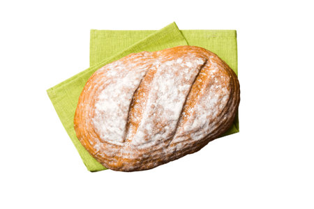 Freshly baked delicious french bread with napkin isolated on white background top view. Healthy white bread loaf.の写真素材