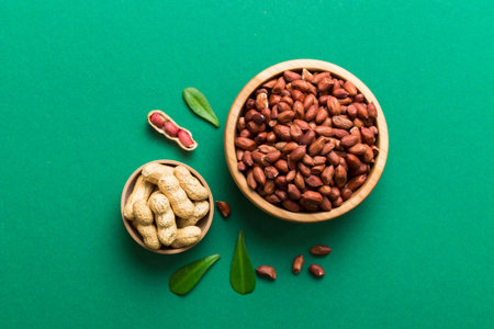 Fresh healthy peanuts in bowl on colored table background. Top view Healthy eating bertholletia concept. super foods.の写真素材