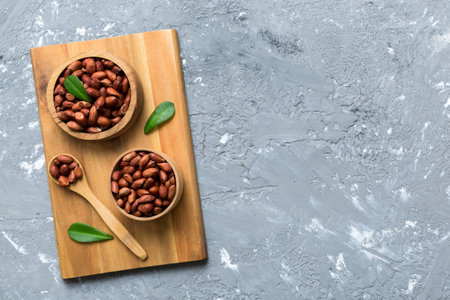 Fresh healthy peanuts in bowl on colored table background. Top view Healthy eating bertholletia concept. super foods.の写真素材